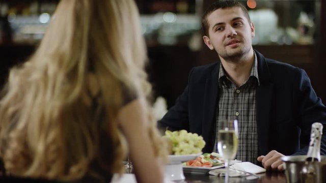 young beautiful pair talking in restaurant partner in restaurant