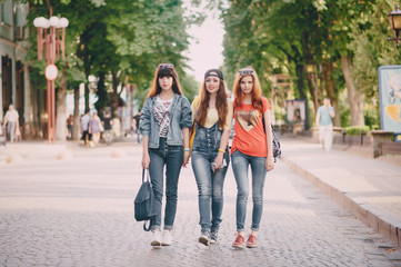 three young girls walking in the park