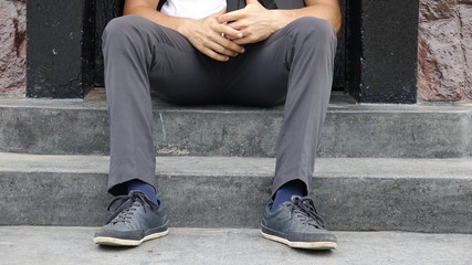 Legs And Feet Of Man Sitting