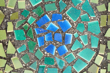 Grunge texture of green and blue broken tiles on old wall