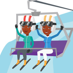 Two happy skiers using cableway at ski resort.