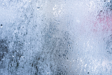 Glass with condensation, natural water drops on glass, high humidity, large drops of water flow...