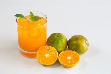 Fresh orange and juice in glass on white background