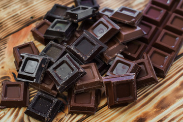 Chocolate pieces on a wooden background