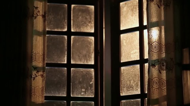 Old dirty and fabulous window opens outwards. Night time.