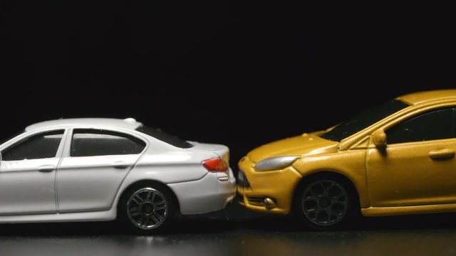 ACCIDENT: Yellow toy model car crashes to white toy car (slow motion)