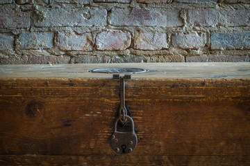 The old and wooden chest in a room.