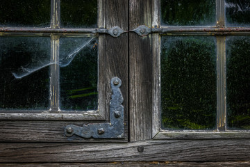 The  window of an old,wooden farmhouse