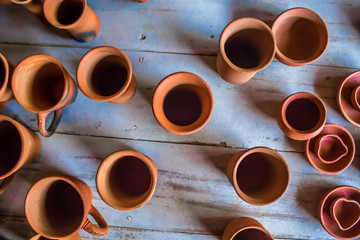 Top view of indian traditional handmade pottery of different sized cups, lamps, and jugs, Chennai, India, Feb 25 2017