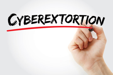 Hand writing cyberextortion with marker, concept background