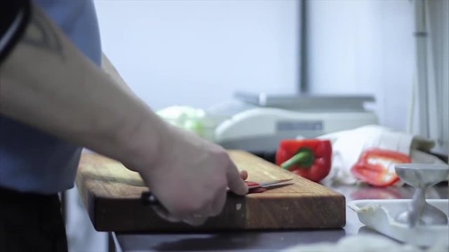 chef hands slicing sweet Red Bell Pepper