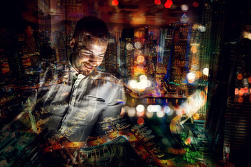 Night late work businessman typing working on laptop. Business concept dark city background cityscape lights future.