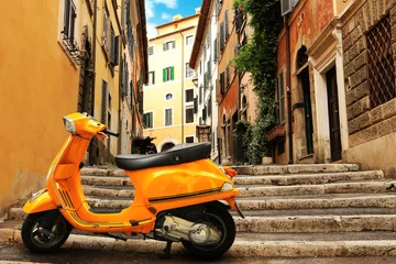 Poster Oranje vintage scooter op de achtergrond van Rome street © Zarya Maxim
