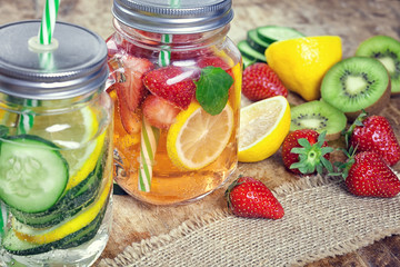 Fototapeta na wymiar Infused Water with Fresh Strawberries, Lemon, Cucumber, Kiwi and Mint 