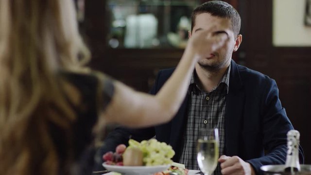 back view of a woman arguing with man in restaurant