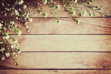 White flower on grunge wood board background with space.