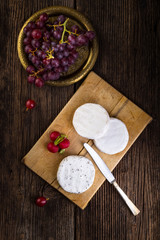 Cheese with white mold, grapes and radish