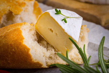 Cheese with white mold, radish, grapes and baguette with herbs