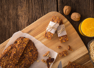 Cereal bars with raisins, nuts and orange juice.