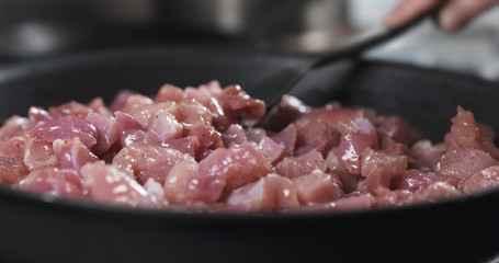mixing pork meat frying on pan cooking pilaf, 4k photo