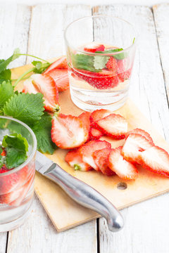 refreshing drink with strawberries and mint on a white background