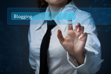 Business, technology, internet and networking concept. Business woman presses a button on the virtual screen: Blogging
