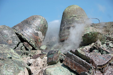 Stones of byproduct plant waste with vapour in industrial quarry