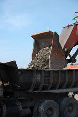 Fototapeta premium Industrial equipment excavator in quarry load stones 