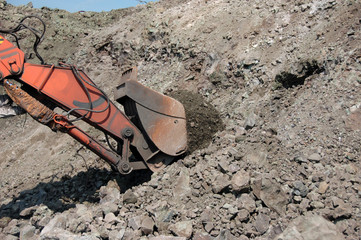 Industrial equipment excavator in quarry load stones 