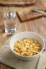 dry corn flakes for breakfast in bowl on table, breakfast preparation