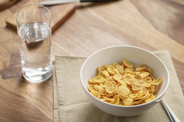 dry corn flakes for breakfast in bowl on table, breakfast preparation