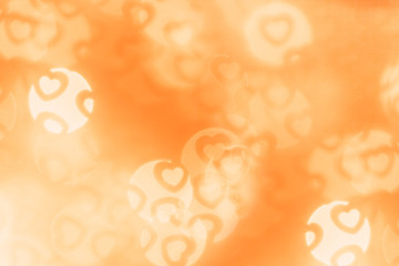  Valentine's day abstract background of soft orange bokeh blur hearts. Festive valentine backdrop.