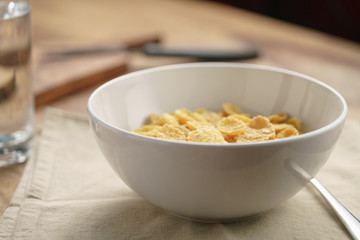dry corn flakes for breakfast in bowl on table, breakfast preparation