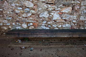Wooden Bench at Medieval Stone Wall