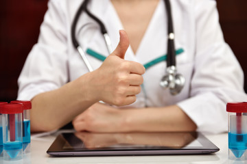 female doctor showing thumb up