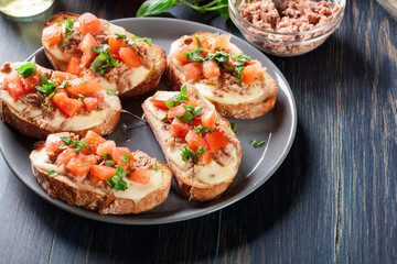 Appetizer bruschetta with tuna, mozarella cheese and tomatoes