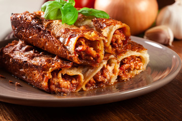 Baked cannelloni with minced meat and bechamel sauce on a plate
