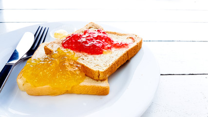 Toast with strawberry and orange yam on plate