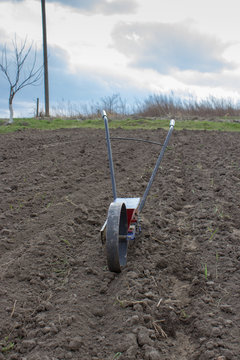 spreader on the with seeds soil