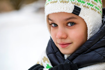 Close up portrait of a cute little girl in winter time