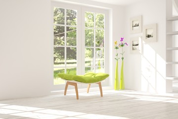 White room with chair and green landscape in window. Scandinavian interior design