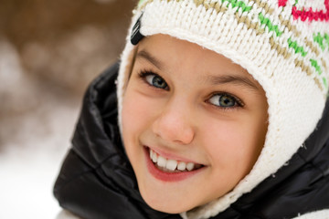 Close up portrait of a cute little girl in winter time
