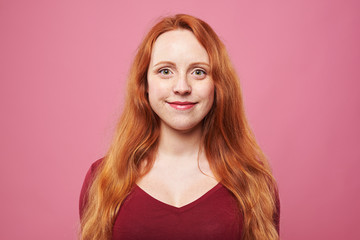 Woman with red hair and freckles isolated over background