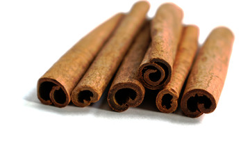 Closeup of cinnamon sticks on a white background