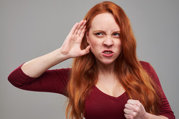 Angry woman eavesdropping gossip