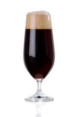 dark beer with foam on white .