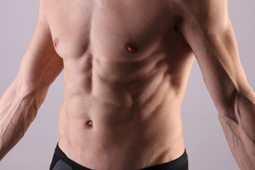 Fototapeta premium Close up of muscular male torso, chest and armpit hair removal. Male Waxing