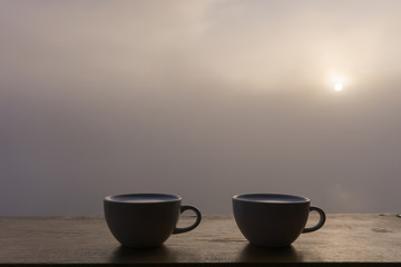 cup of coffee at sunrise in the morning