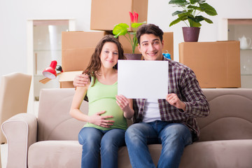 Young couple expecting baby with blank message