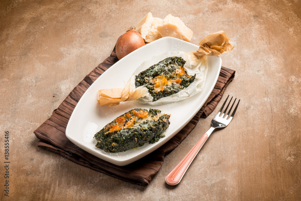 Poster wrapped spinach with parmesan cheese oven cooked